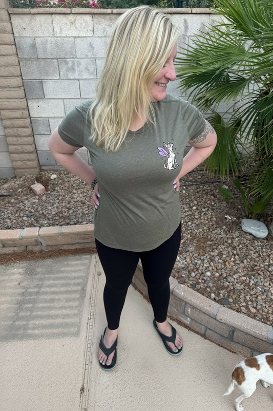 Woman wearing a soft green t-shirt with a fairy dog graphic design on the front.